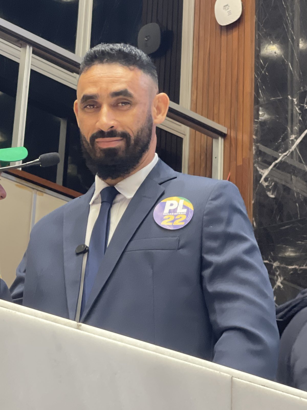 Valdeci Medeiros Gonçalves, de terno azul com broche do PL 22, discursando ao microfone na tribuna
